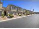 Townhome exterior features multiple garages, desert landscaping and visible unit numbers at 3783 Canis Minor Ln # 6104, Henderson, NV 89052