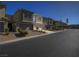 Exterior view of contemporary townhomes with individual garages and community landscaping at 3783 Canis Minor Ln # 6104, Henderson, NV 89052