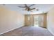 Spacious bedroom with ceiling fan and a sliding door to a balcony at 3820 Ice Storm Ct, Las Vegas, NV 89129
