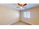 Cozy bedroom with a ceiling fan and plantation shutters on the window at 3820 Ice Storm Ct, Las Vegas, NV 89129
