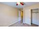 A cozy bedroom features carpeted floors, a ceiling fan, and a convenient closet for ample storage at 3820 Ice Storm Ct, Las Vegas, NV 89129