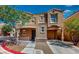 Inviting two-story home with a warm, earthy facade and an attached garage at 3820 Ice Storm Ct, Las Vegas, NV 89129