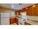 Bright kitchen equipped with white appliances, granite counters, and wooden cabinets at 3820 Ice Storm Ct, Las Vegas, NV 89129
