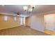 Expansive living room with neutral carpeting, a ceiling fan, and access to the outdoors at 3820 Ice Storm Ct, Las Vegas, NV 89129