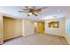 Inviting living area with neutral tones, carpet flooring, and a view into the kitchen at 3820 Ice Storm Ct, Las Vegas, NV 89129