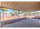 Spacious backyard featuring a covered patio, a large gravel area, and a privacy fence at 4000 Twain Ave, Las Vegas, NV 89121