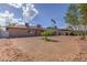 Large backyard with gravel landscaping, shade trees, and a glimpse of the rear exterior of the house at 4000 Twain Ave, Las Vegas, NV 89121