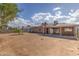 Expansive backyard with a covered patio, gravel landscaping, and a view of the home's exterior at 4000 Twain Ave, Las Vegas, NV 89121