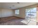 Bedroom with large windows offering natural light, plush carpet, and access to a covered patio at 4000 Twain Ave, Las Vegas, NV 89121
