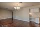 Bright living room featuring hardwood floors, a stylish chandelier, and a built-in desk with ample storage at 4000 Twain Ave, Las Vegas, NV 89121
