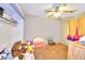 This bedroom boasts carpeted floors and a ceiling fan with overhead lighting at 4145 Plumtree St, Las Vegas, NV 89115