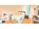 This bedroom features a bed, dresser, vanity, and window with light blue curtains at 4145 Plumtree St, Las Vegas, NV 89115