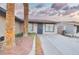 Charming entryway with decorative landscaping, an iron gate, and a concrete path at 4145 Plumtree St, Las Vegas, NV 89115
