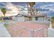 Single-story home showcasing a xeriscaped front yard and a quaint, fenced garden at 4145 Plumtree St, Las Vegas, NV 89115