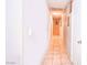 Well-lit hallway featuring neutral paint and tile flooring to other rooms at 4145 Plumtree St, Las Vegas, NV 89115