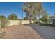 Desert landscaped backyard with perimeter wall, greenery, gravel, and a shade tree at 4620 Standing Bluff Way, Las Vegas, NV 89130