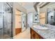 Bright bathroom showcasing double sinks, granite countertops, and mirrored closet doors at 4620 Standing Bluff Way, Las Vegas, NV 89130