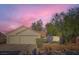 Charming single-story home with a two-car garage, desert landscaping, and vibrant sunset sky at 4620 Standing Bluff Way, Las Vegas, NV 89130