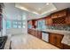 Open kitchen features granite counters, stainless steel appliances, wood cabinets, and sunlit breakfast nook at 4620 Standing Bluff Way, Las Vegas, NV 89130