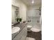 Bright bathroom with granite vanity, white cabinets, and a glass-enclosed shower at 532 Clearsable Ave, Henderson, NV 89044