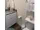 Compact bathroom with granite countertop, white cabinetry, toilet, and modern fixtures at 532 Clearsable Ave, Henderson, NV 89044