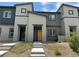 Charming townhome featuring a yellow front door, modern architecture, and well-maintained landscaping at 532 Clearsable Ave, Henderson, NV 89044