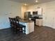 Modern kitchen with granite counters, stainless steel appliances, and breakfast bar at 532 Clearsable Ave, Henderson, NV 89044