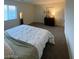 Calm bedroom with cozy duvet, dresser, and natural light from a bright window at 532 Clearsable Ave, Henderson, NV 89044