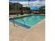Community pool features clear water, blue umbrellas, lounge chairs and desert landscaping at 532 Clearsable Ave, Henderson, NV 89044