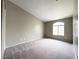 A spacious bedroom with carpet, a large window, and neutral colored walls at 5359 Harvest Breeze Rd, Las Vegas, NV 89118