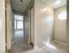 Carpeted hallway with a decorative window allowing natural light to enter the home at 5359 Harvest Breeze Rd, Las Vegas, NV 89118