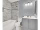 Updated bathroom features tiled shower over tub, new vanity, mirror, and updated fixtures at 584 Sellers Pl, Henderson, NV 89011