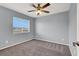 This bedroom features neutral walls, carpeted floors, and a ceiling fan with light fixture at 584 Sellers Pl, Henderson, NV 89011