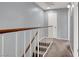 Bright upstairs hallway featuring carpet floors, white doors, and a modern staircase at 584 Sellers Pl, Henderson, NV 89011