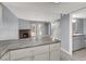 Open concept kitchen flows into the living area with a fireplace and access to the bathroom and staircase at 584 Sellers Pl, Henderson, NV 89011