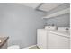 Laundry room features a new washer and dryer and storage shelf, with tile flooring at 584 Sellers Pl, Henderson, NV 89011