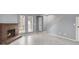 Spacious living room features a classic brick fireplace, neutral tile floors, and a staircase at 584 Sellers Pl, Henderson, NV 89011