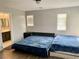Bedroom featuring twin beds, laminate wood-look flooring and access to a private bathroom at 6182 Blue Rapids Ct, Las Vegas, NV 89139