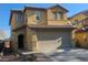 Two-story home featuring a large two car garage, stucco siding, and a tile roof at 6182 Blue Rapids Ct, Las Vegas, NV 89139