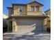 Two-story home featuring a large two car garage, stucco siding, and a tile roof at 6182 Blue Rapids Ct, Las Vegas, NV 89139