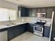Modern kitchen with stainless steel appliances, sleek dark cabinetry, and ample counter space at 6182 Blue Rapids Ct, Las Vegas, NV 89139