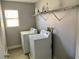 Functional laundry room with shelving above side-by-side washer and dryer at 6182 Blue Rapids Ct, Las Vegas, NV 89139