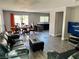 Spacious living room featuring modern gray paint, laminate flooring and access to the backyard at 6182 Blue Rapids Ct, Las Vegas, NV 89139