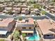 An aerial view shows a home with a solar roof and a gorgeous backyard pool in the community at 648 Sunrise Lake Pl, Henderson, NV 89002