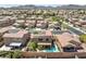 An aerial view displays a home with a solar roof and a beautiful backyard pool in the community at 648 Sunrise Lake Pl, Henderson, NV 89002