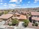 Beautiful aerial view of a two-story home with solar panels nestled in a desert community near the mountains at 648 Sunrise Lake Pl, Henderson, NV 89002