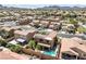 Overhead shot of a solar-paneled roof and pool in a well-planned neighborhood, with mountains in the distance at 648 Sunrise Lake Pl, Henderson, NV 89002