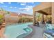 Beautiful backyard with a refreshing pool, covered patio, and lush landscaping at 648 Sunrise Lake Pl, Henderson, NV 89002