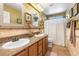 Bathroom featuring double sinks and a shower with a white curtain at 648 Sunrise Lake Pl, Henderson, NV 89002