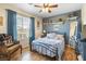 Cozy bedroom with neutral paint, wood floors, and a ceiling fan at 648 Sunrise Lake Pl, Henderson, NV 89002